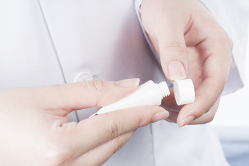 Woman hands holding cosmetic cream tube