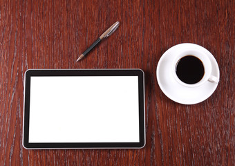 Tablet, coffee and pen on the desk