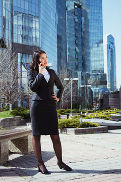 Portrait of a cute business woman over business center on back