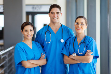 group of young hospital workers in scrubs - obrazy, fototapety, plakaty