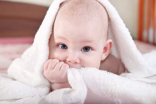 Baby under white towel