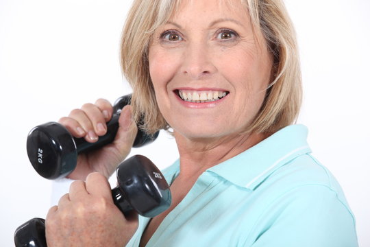 A Middle Age Woman Lifting Weights.