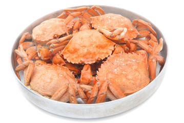 five red boiled crabs in a saucepan isolated on white background