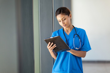 young female medical nurse using tablet computer