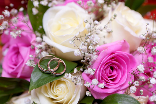 Gold wedding rings on flower