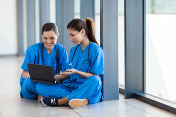 two nurses using laptop computer during break