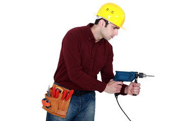 Profile shot of carpenter with power drill