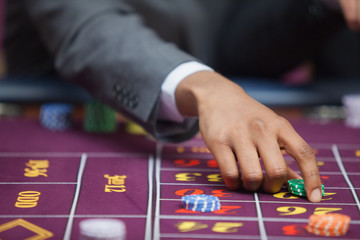 Man in casino placing bet