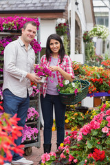 Fototapeta premium Couple holding bouquet and basket