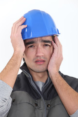 craftsman holding his head