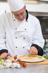 Happy chef making pizza