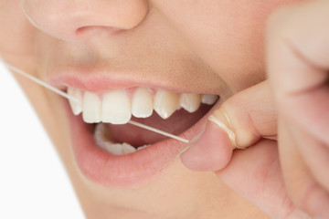 Obraz premium Close up of mouth and dental floss
