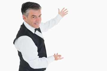 Well-dressed man showing us something