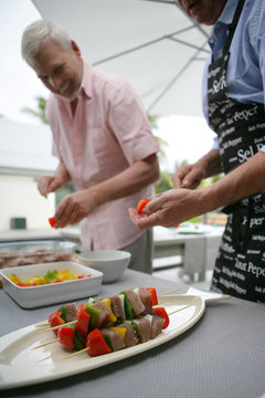 Two Men Making Skewers