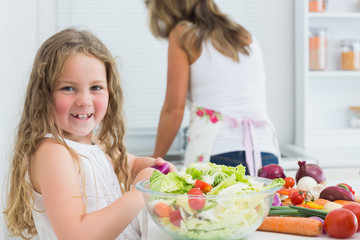Girl preparing vegetable salad