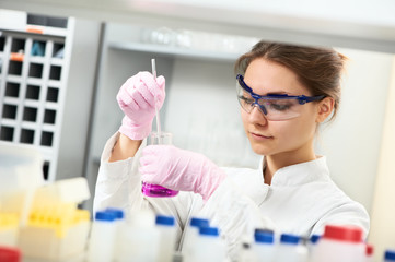 Woman chemist scientist researcher in laboratory