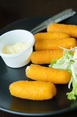 fried cheese with mustard served on dish