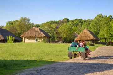 People sitting in the wooden cart