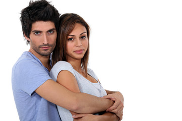 Couple hugging, studio shot
