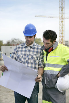 Foreman and colleague checking construction progress
