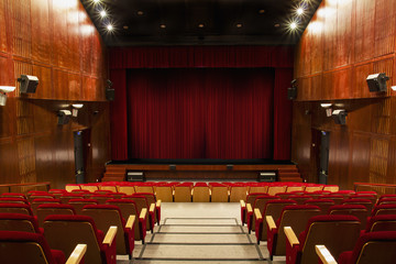 auditorium with red chairs and red curtain - obrazy, fototapety, plakaty