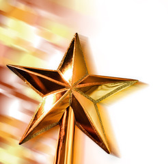 New year golden star in motion on bright bokeh background