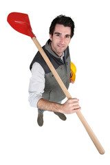 Fototapeta premium Tradesman carrying a spade