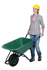 Woman wheeling wheelbarrow