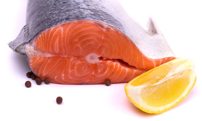 Raw salmon with lemon and pepper isolated on white