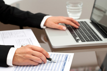 Fototapeta premium Female hands reviewing documents.