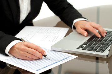 Close up of business woman's hands working.