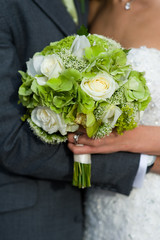 bride and groom with wedding bouquet