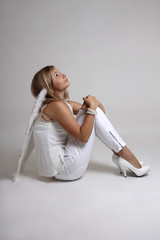 Fototapeta premium Girl with wings sitting and dreaming