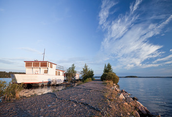 Small white pleasure boat moored on Saimaa lake, Finland