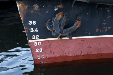 Bow of the cargo ship with anchor and draft scale numbering