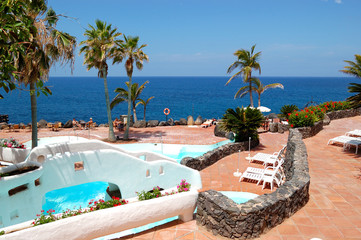 View on the beach, palms and swimming pool of luxury hotel, Tene