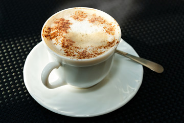 A cup of hot coffee on the table