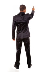 Full length of a African business man pointing at copyspace isol