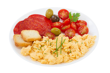 scrambles eggs with tomato and sausages on the plate
