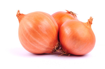 Three bulbs of brown onion on white background