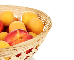 Ripe fruit in basket on white background close-up