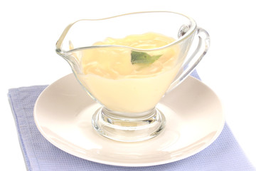 Mayonnaise in bowl on napkin isolated on white