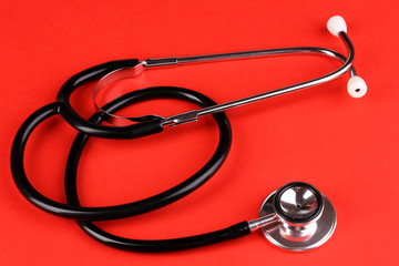 Stethoscope on red background