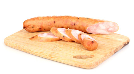 Tasty sausage on chopping board isolated on white