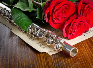 Silver flute, notes and roses. Musical background. © Tryfonov