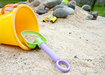 child fun play game with bucket and sand