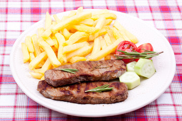 grilled steak with french fries and salad