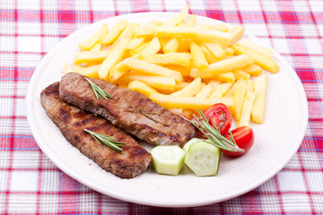 grilled steak with french fries and salad