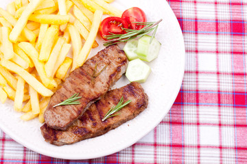 grilled steak with french fries and salad