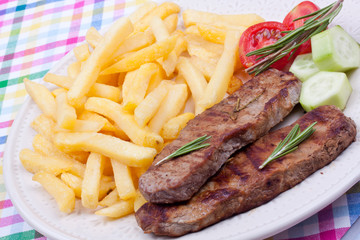 grilled steak with french fries and salad